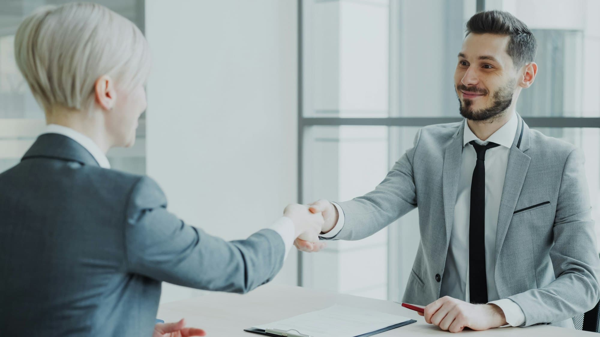 Two professionals shaking hands after a meeting
