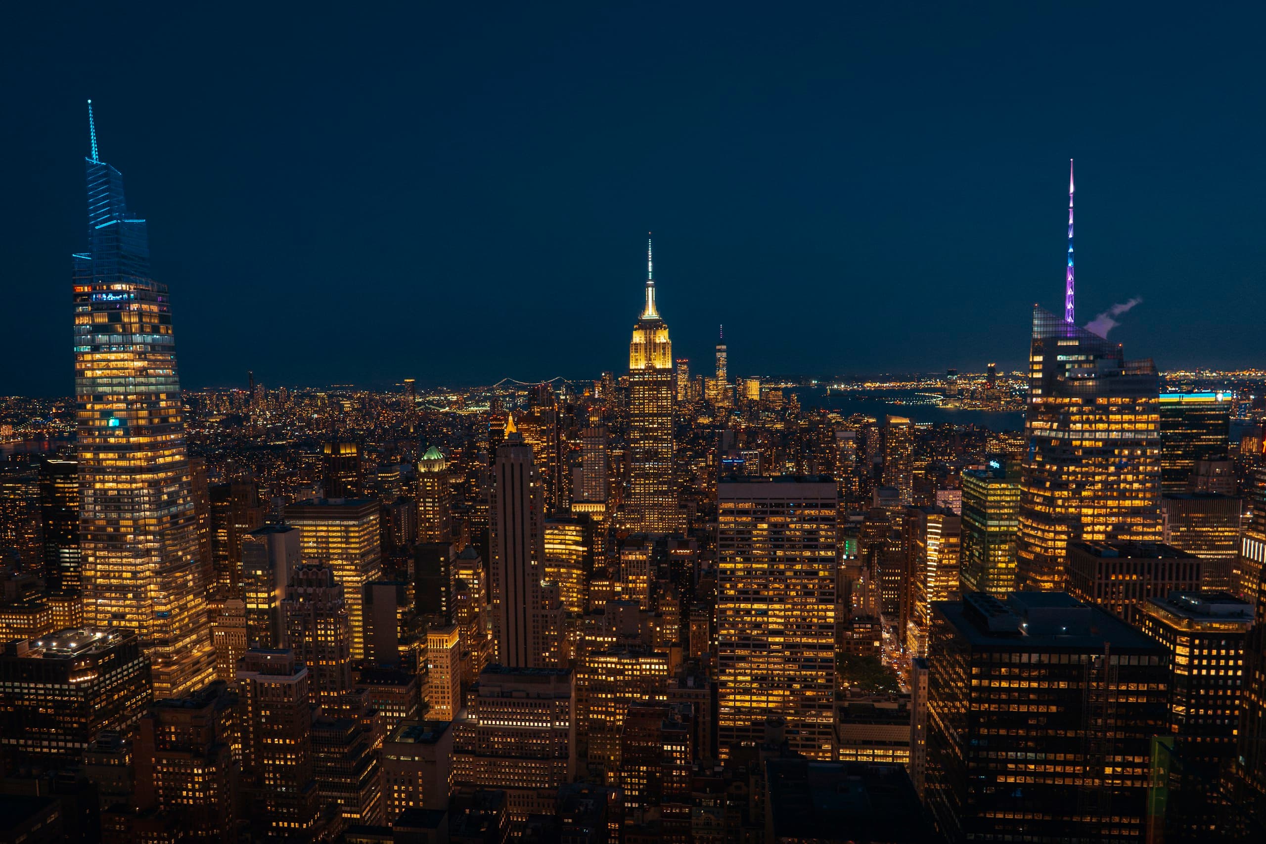 Manhattan skyline at night, with the Empire State Building illuminated